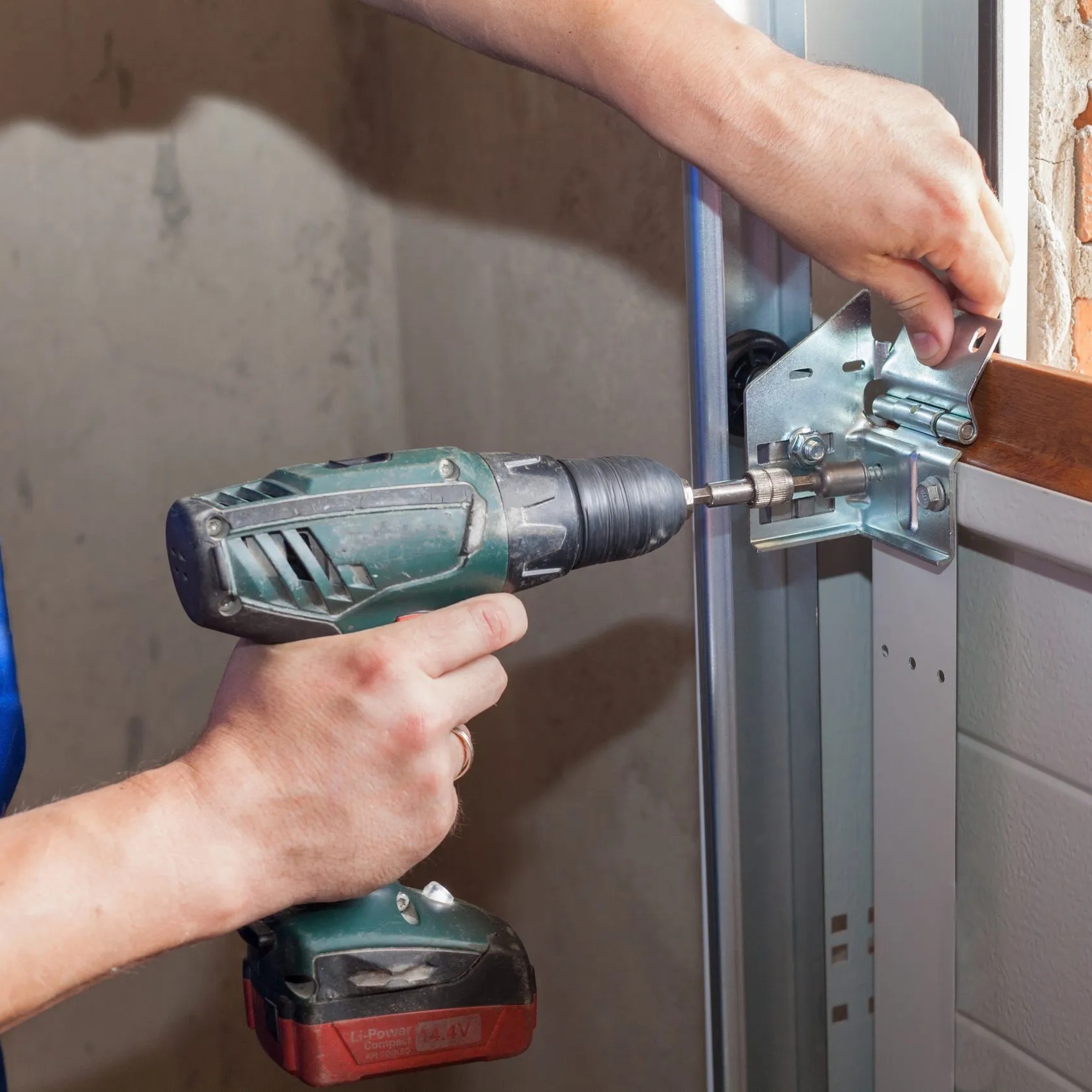 Technician repairing garage door