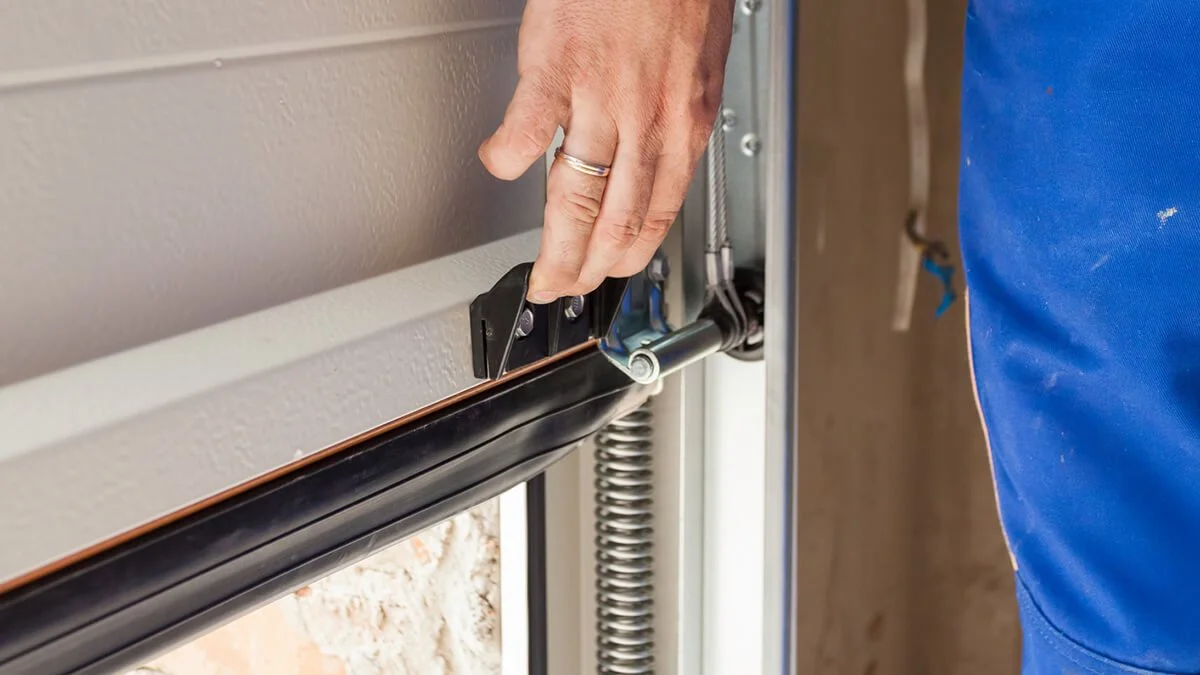Technician repairing garage door