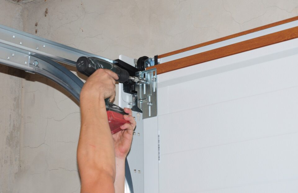 Technician repairing garage door