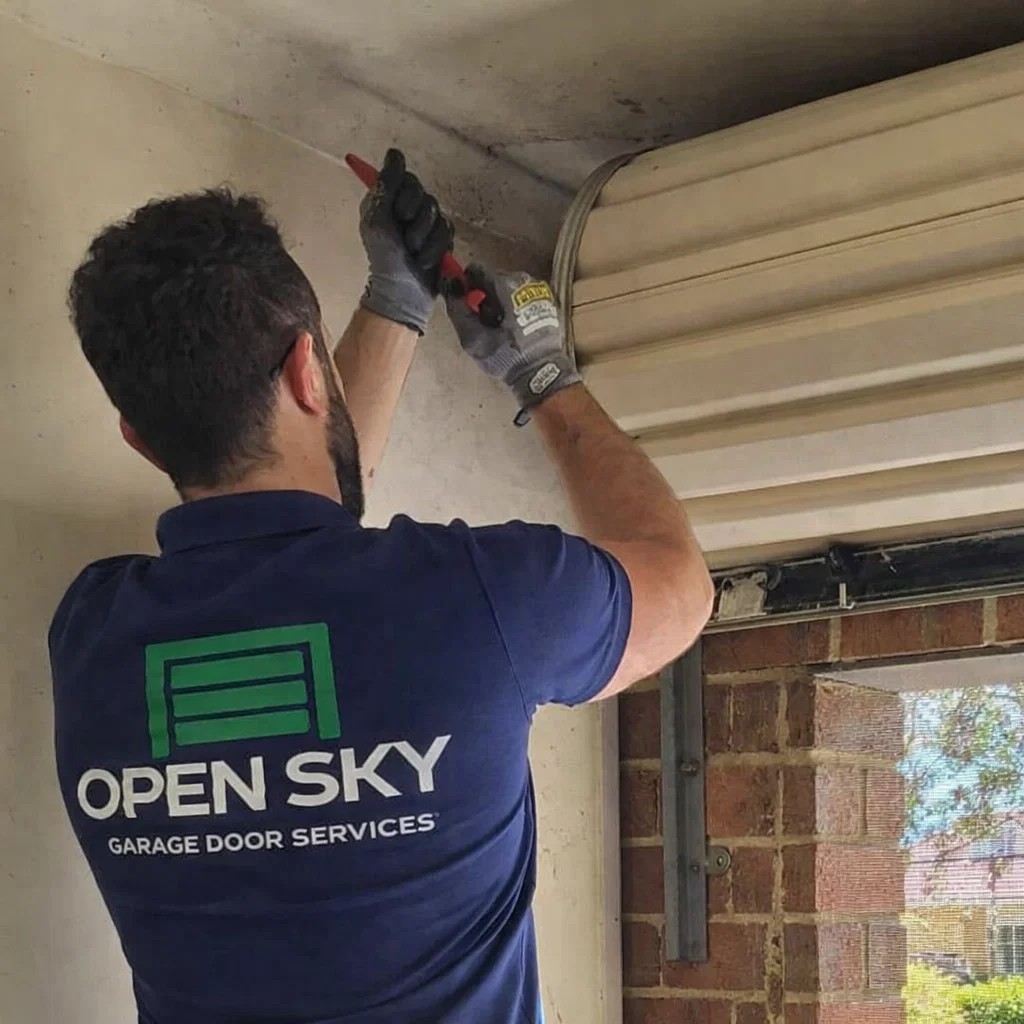 Technician repairing garage door